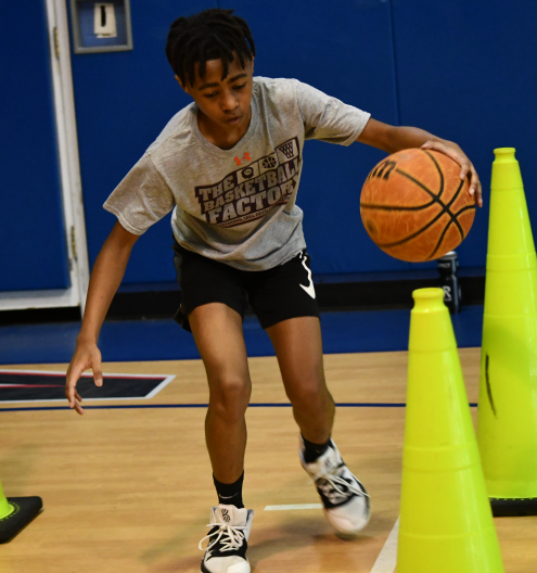 Youth player dribbling through cones at TBF training